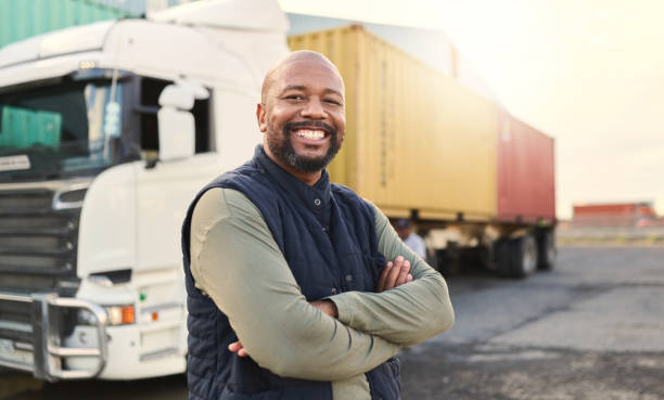 Delivery, container and happy truck driver moving industry cargo and freight at a shipping supply chain or warehouse. Smile, industrial and black man ready to transport ecommerce trade goods or stock